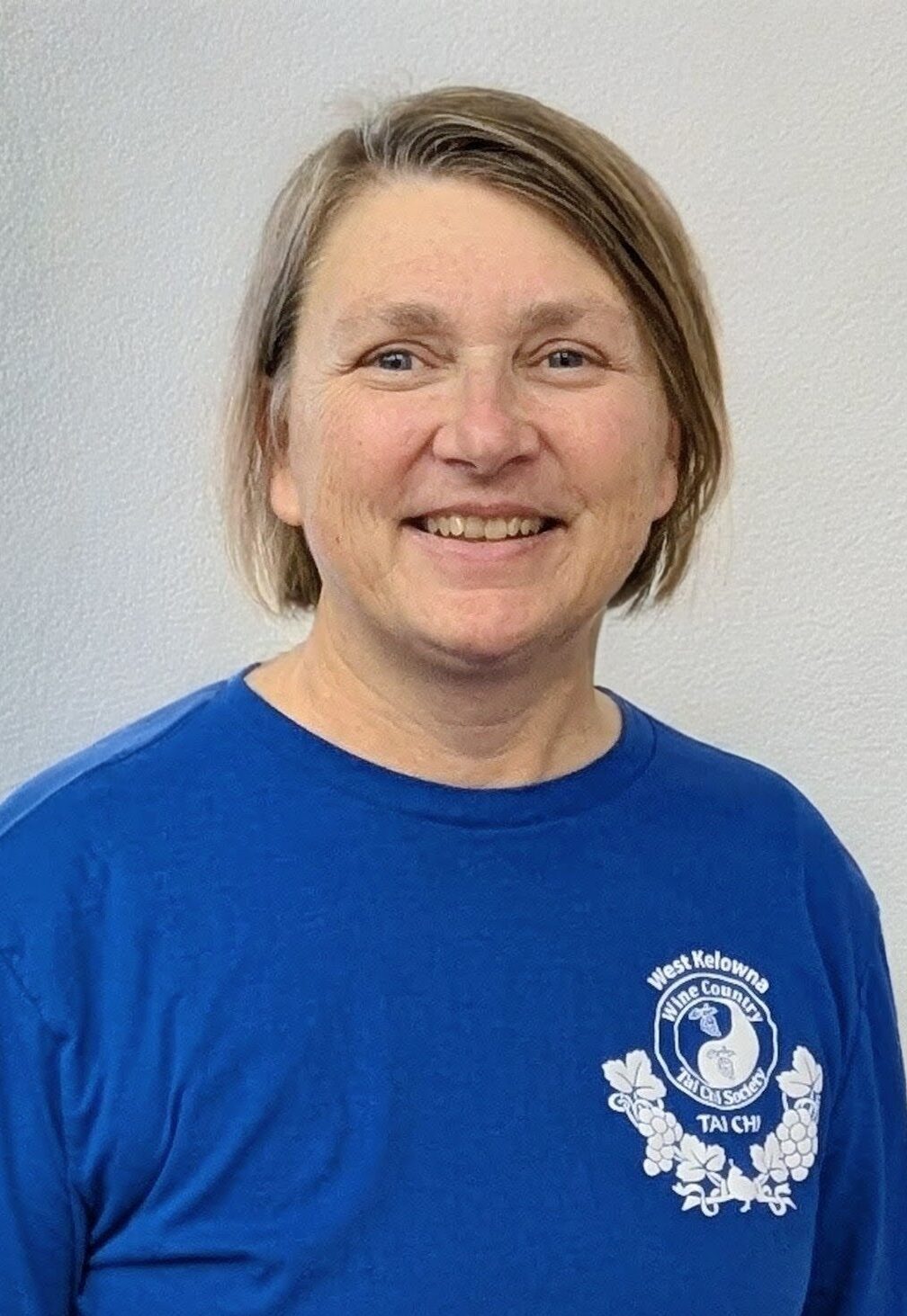 Karen Westhouse picture of a middle aged woman with a Tai Chi shirt on