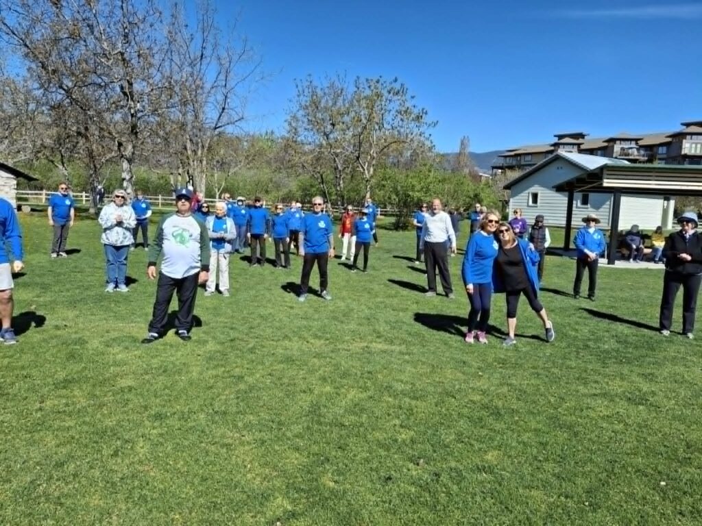 A group of 46 men and women over 60 gathered in the park doing Tai Chi
