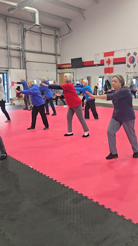 Tai Chi participants in a gym