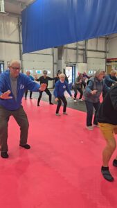 people in a dojo doing tai chi